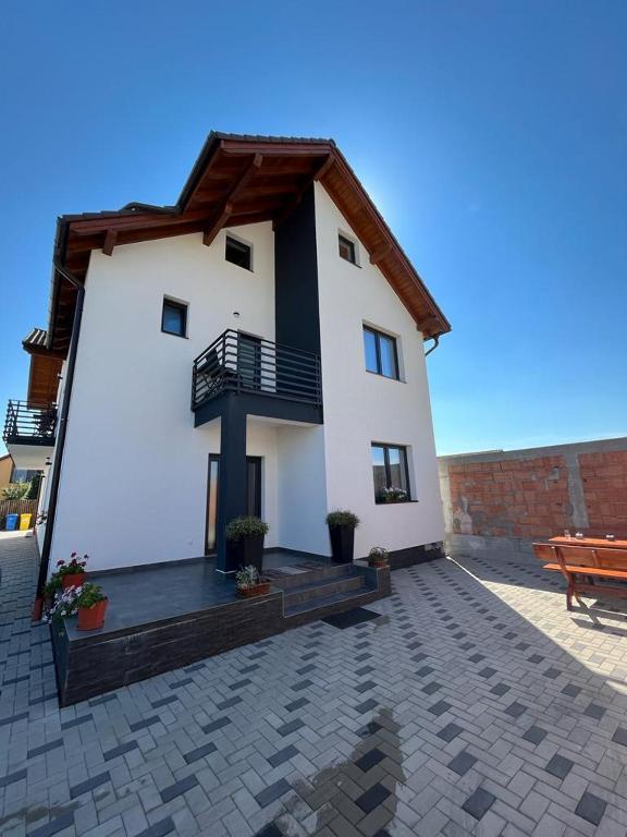 a large white house with a balcony and a patio at Casa Lucia in Sibiu