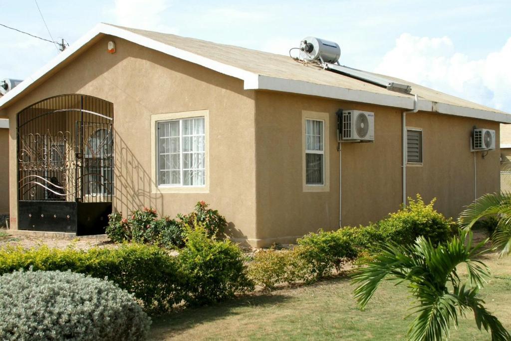 a house with an air conditioner on top of it at Sassy Diamond Crest in Portmore