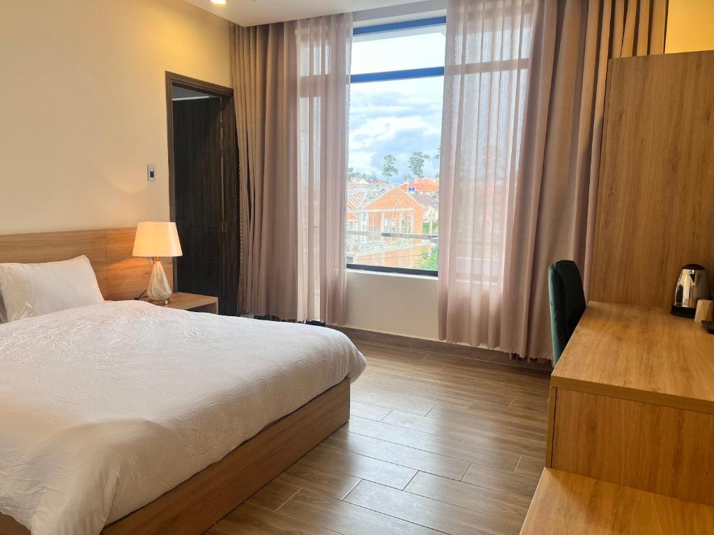 Postel nebo postele na pokoji v ubytování Q's House Dalat