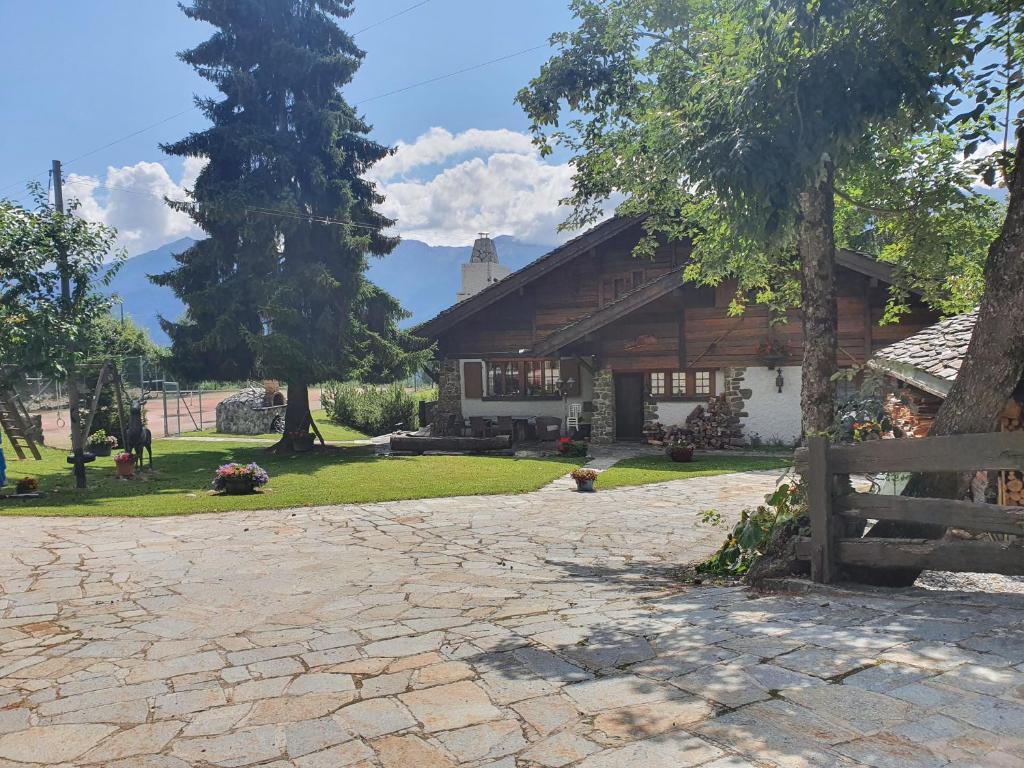 a house with a stone driveway in front of it at Chalet Charme Ovronnaz in Ovronnaz