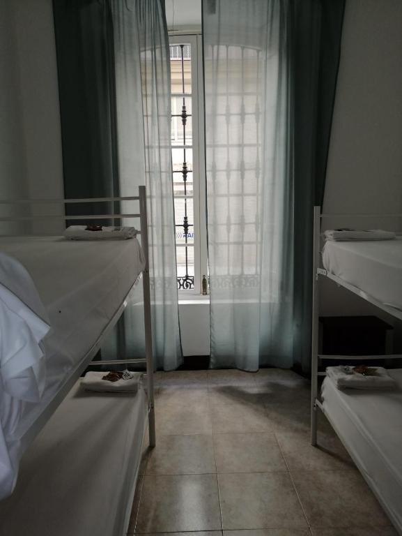 Postel nebo postele na pokoji v ubytování Residencia Universitaria San José
