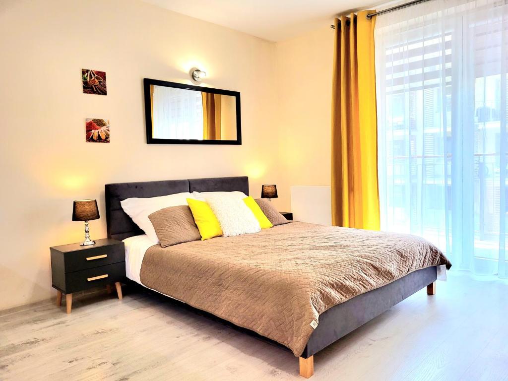 a bedroom with a bed and a large window at Cracow NOVUM Apartment Downtown free parking 4 os in Kraków