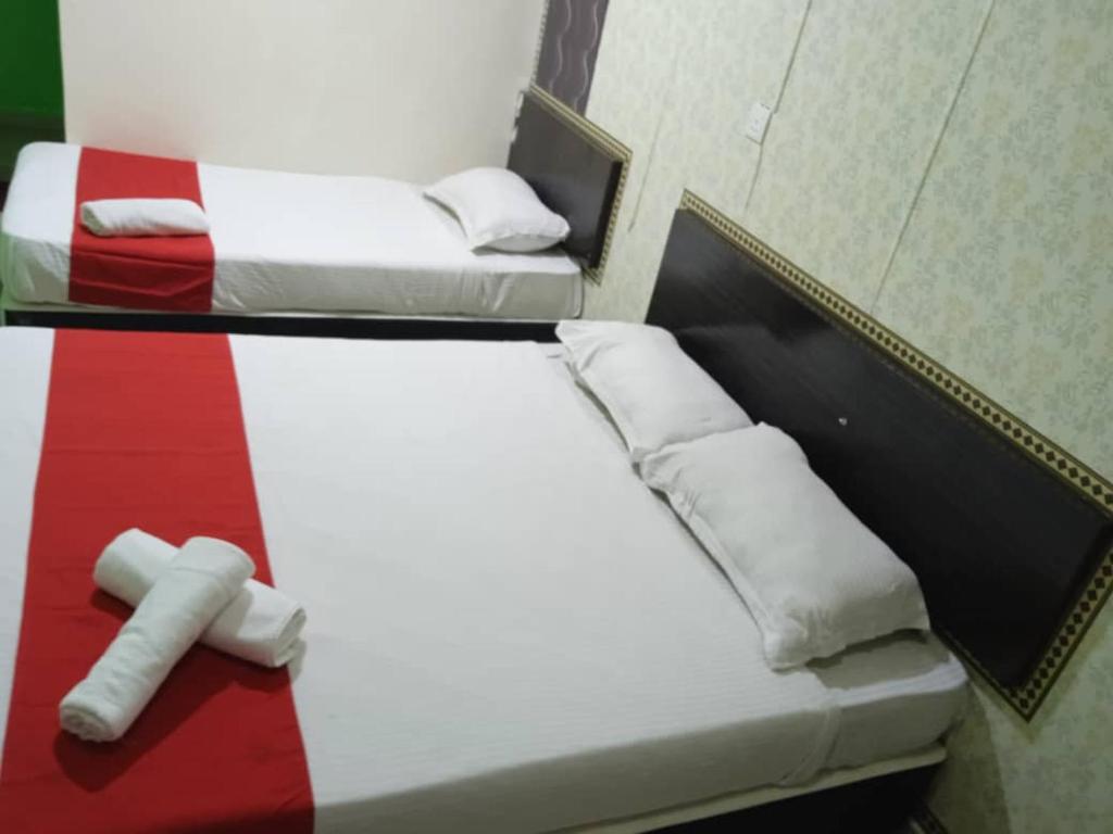 Postel nebo postele na pokoji v ubytování EZI HOTEL KLANG
