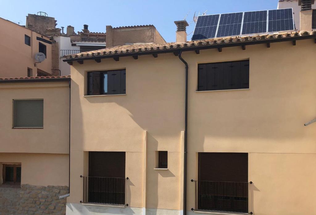 a house with solar panels on the roof at Casa Rural El Corral del Tío Santiago in Mazaleón
