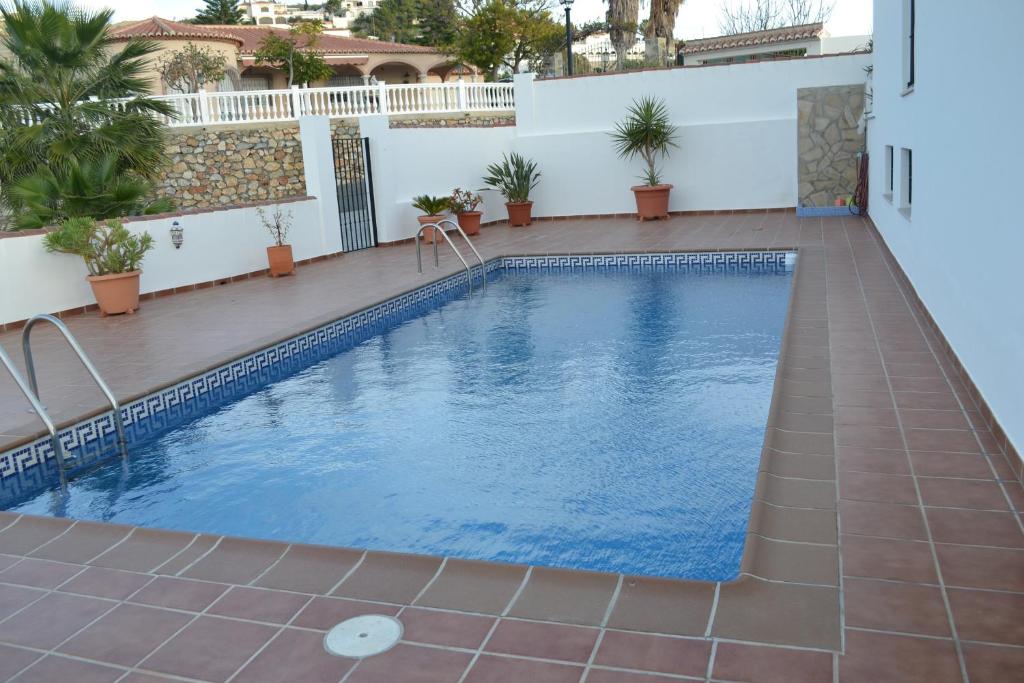 a swimming pool in the middle of a house at Casa Curumbico in Almuñécar