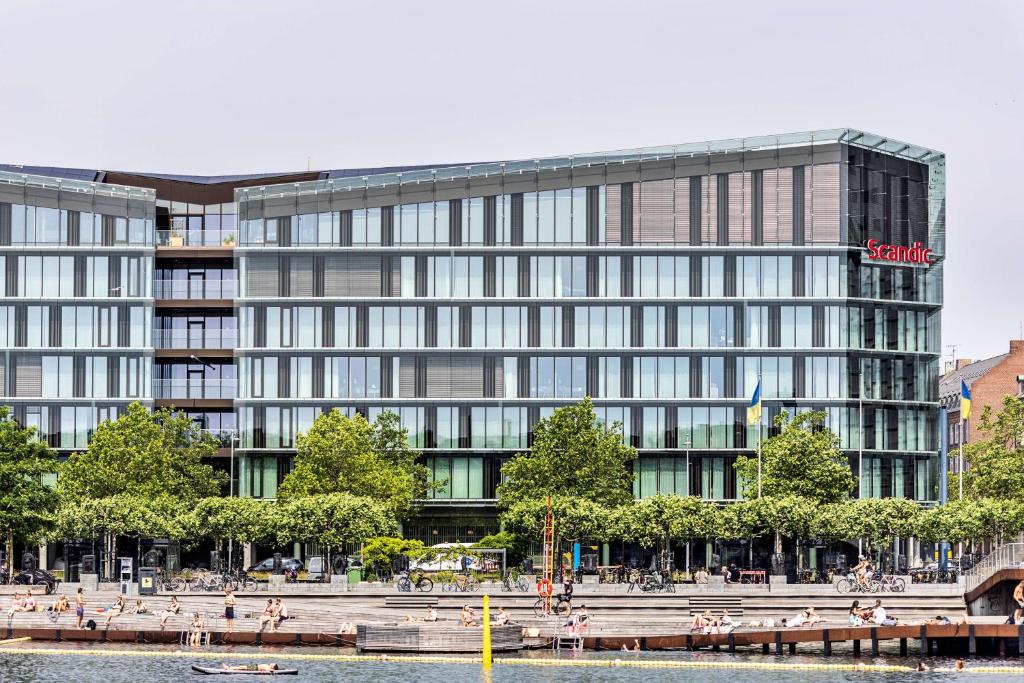 a large building with people sitting in front of it at Scandic Spectrum in Copenhagen