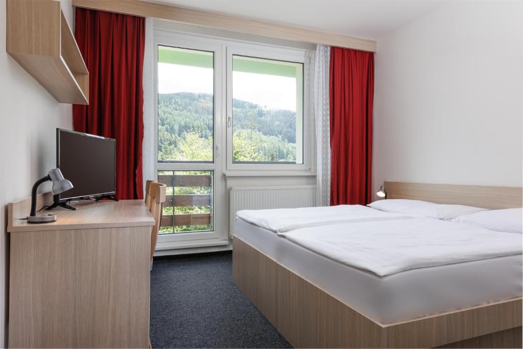Postel nebo postele na pokoji v ubytování Resort Dlouhé Stráně