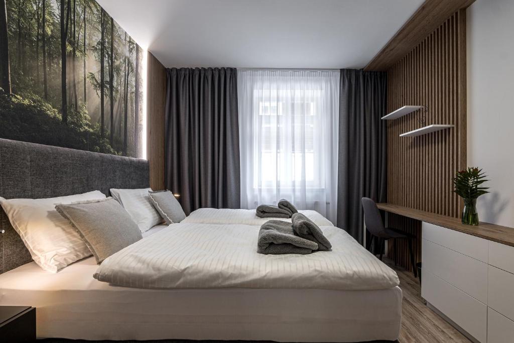 Postel nebo postele na pokoji v ubytování Hubertus Karlova Studánka
