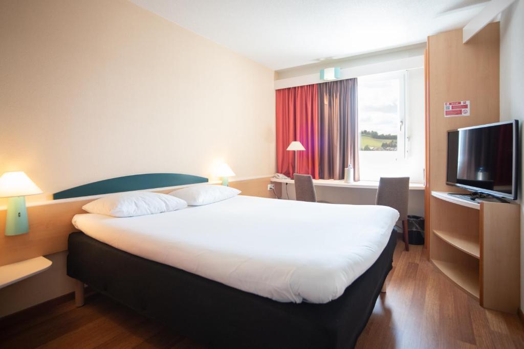 Postel nebo postele na pokoji v ubytování ibis Fribourg