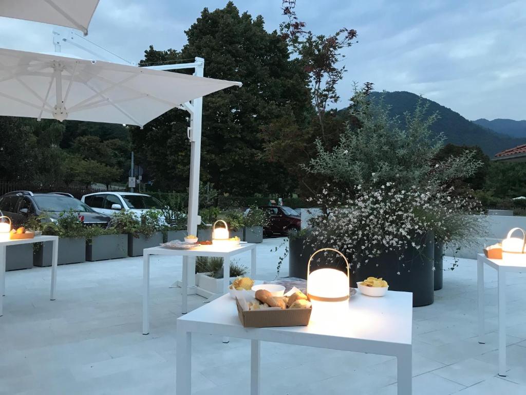 a group of tables with food on a patio at Aldeia Bianca Village in Almenno San Salvatore