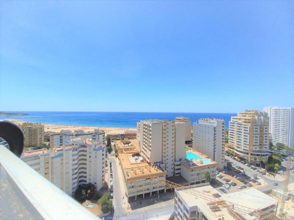 an aerial view of a city with the ocean at Tarik Beach Apartment in Portimão