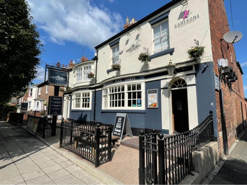 a blue and white building on a city street at The Grey Horse in Darlington