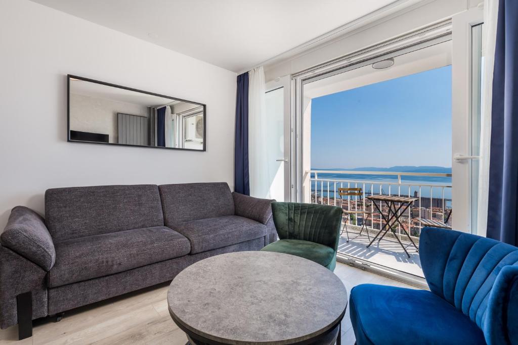 a living room with a couch and a table at Heaven View Apartment in Rijeka