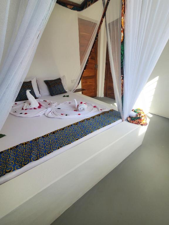 Postel nebo postele na pokoji v ubytování Blue Palm Zanzibar