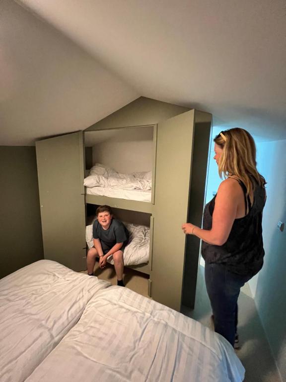 a woman standing in a room next to a bed at Camping Vliegenbos in Amsterdam
