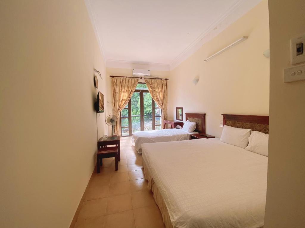 Postel nebo postele na pokoji v ubytování An Phú Motel Tam Đảo