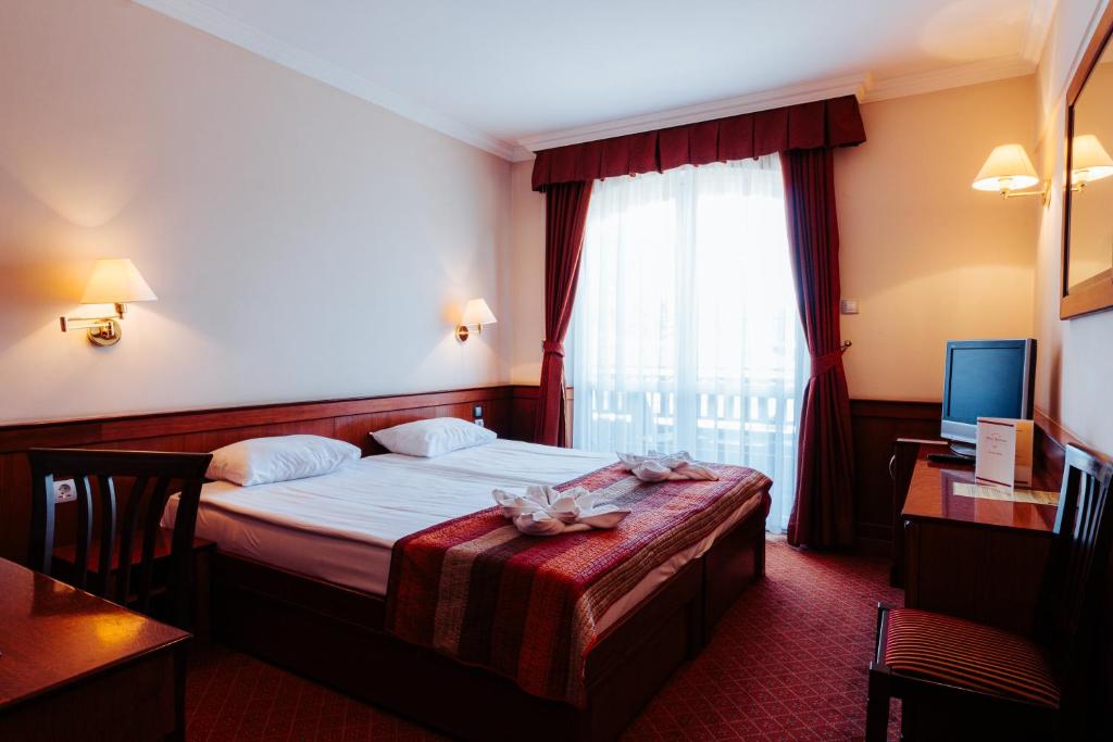 Postel nebo postele na pokoji v ubytování Hotel Ködmön
