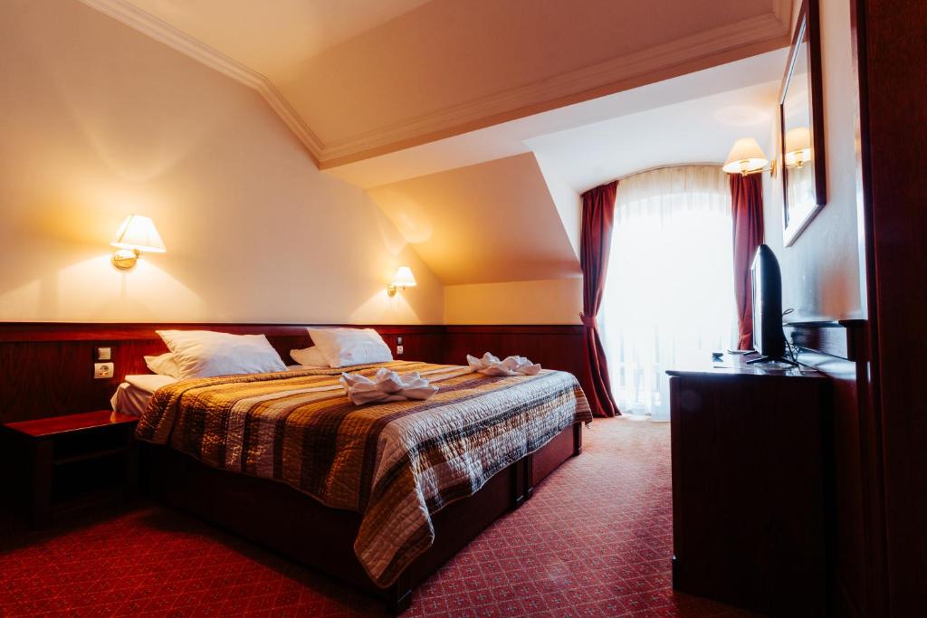 Postel nebo postele na pokoji v ubytování Hotel Ködmön