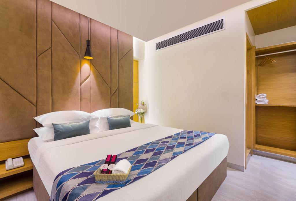a bedroom with a large bed with a basket on it at Hotel Metropole Inn in Mumbai