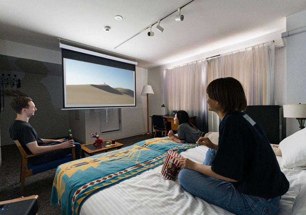 Postel nebo postele na pokoji v ubytování Hotel Graphy Nezu