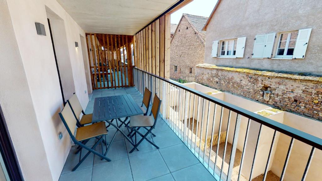 a balcony with a table and chairs on it at Au Pied Du Mont 1 free parking in Obernai