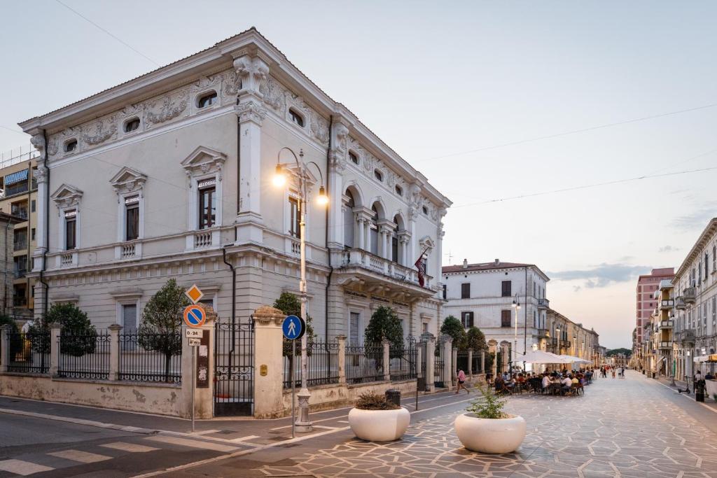 a white building on a street in a city at B&B Lanciano in Lanciano