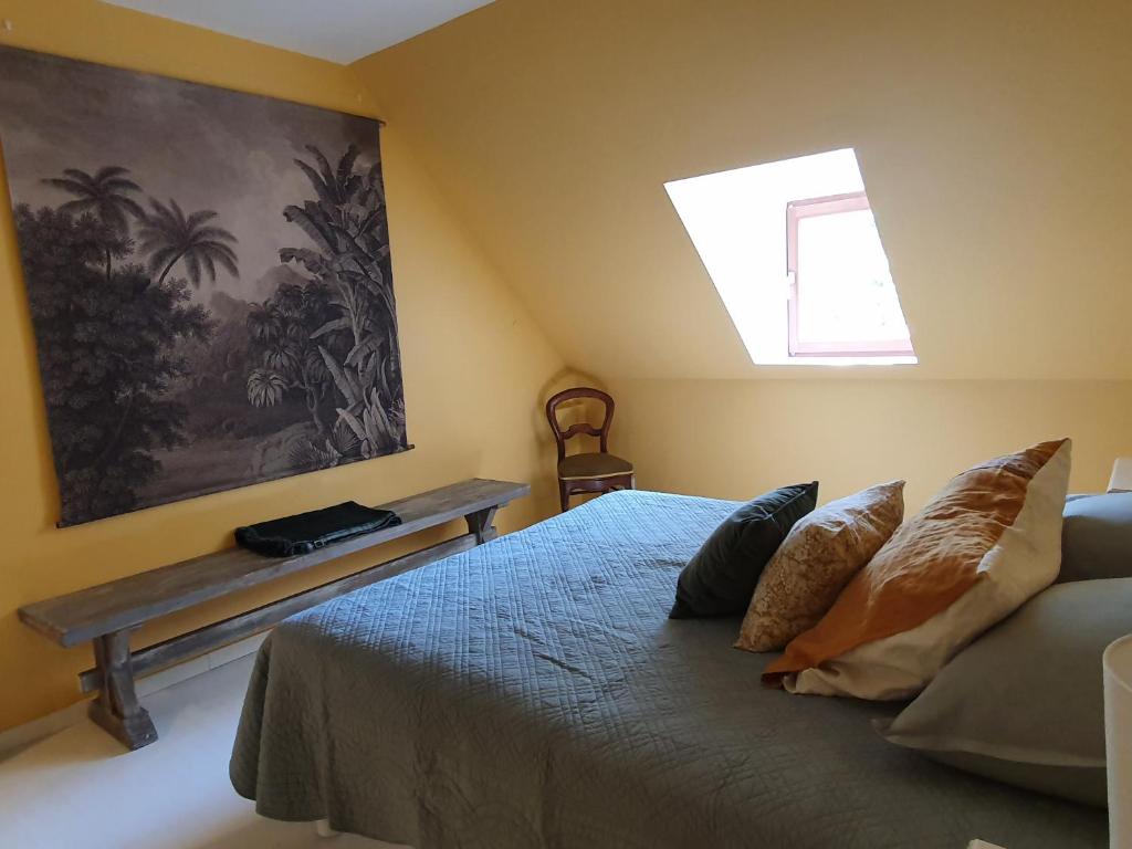 a bedroom with a bed and a skylight at Les Pierres Lotoises - gîte les grandes pierres in Reilhaguet
