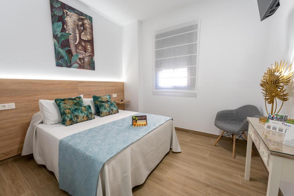 Posteľ alebo postele v izbe v ubytovaní Hostal Romerito
