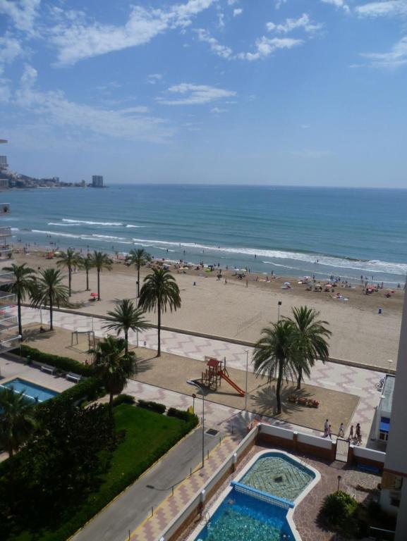 a view of the beach from the balcony of a resort at Montemar, C-12º-33 in Cullera