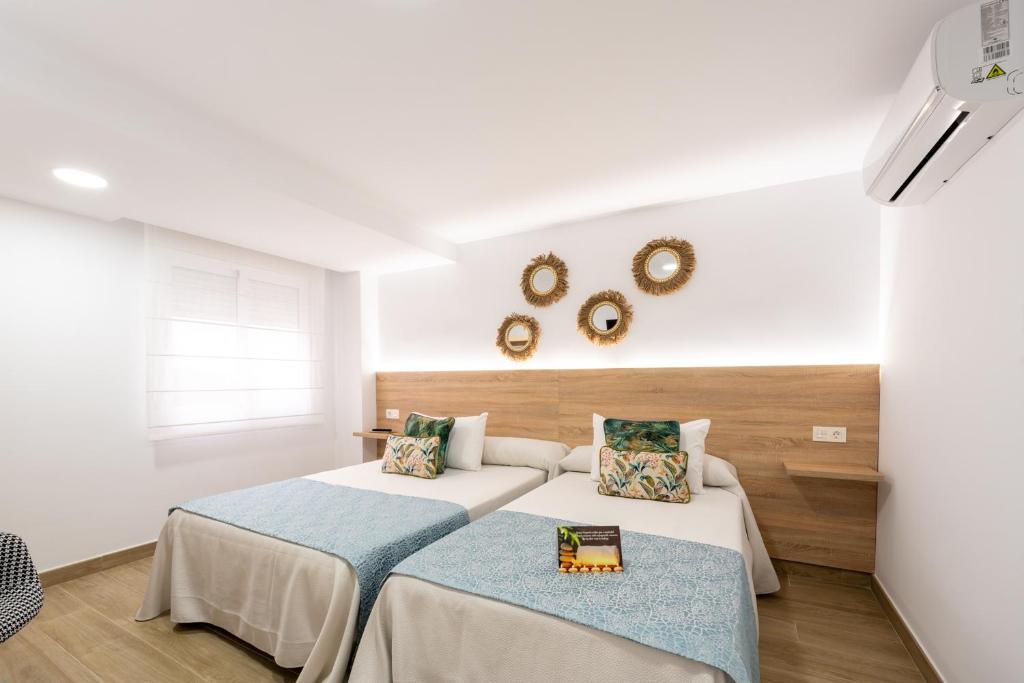Posteľ alebo postele v izbe v ubytovaní Hostal Romerito