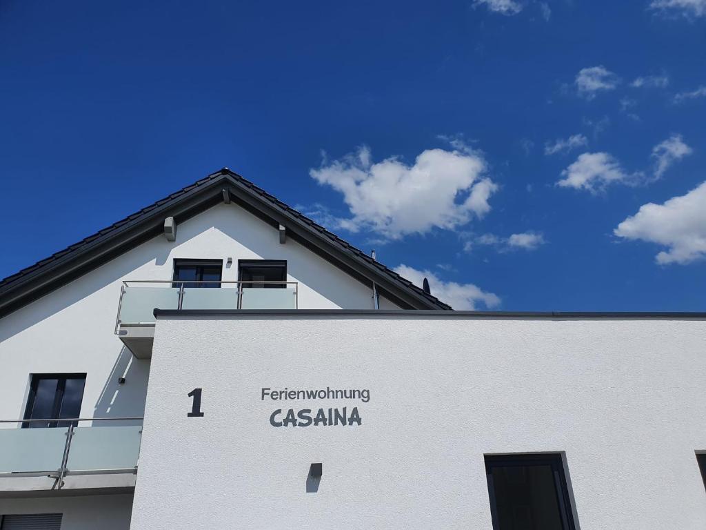 a white building with the words transforming casamanca on it at Casaina in Weisweil