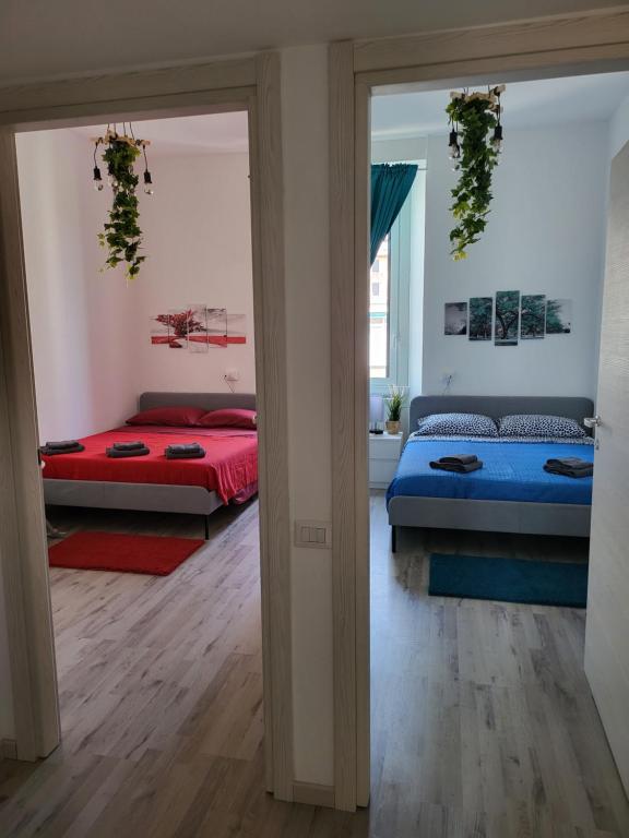 a bedroom with two beds and a window at Dea Dreams APARTMENT Piazzale Lodi Wi-Fi Metro a 2 passi in Milan