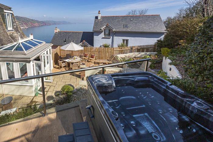 a hot tub on a balcony of a house at 5 Bed - Foxes Walk in Torquay