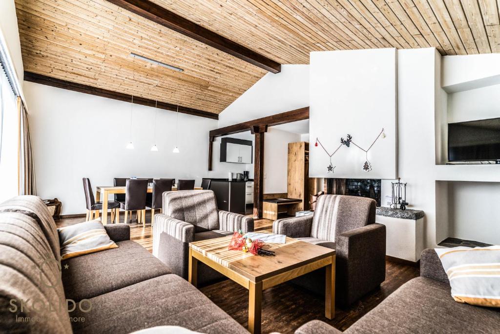 a living room with couches and a table at Haus Camillo in Saas-Fee