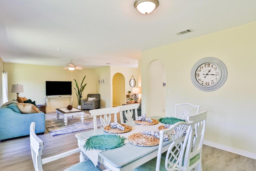 a dining room and living room with a table and chairs at Tropic Way in St. Augustine