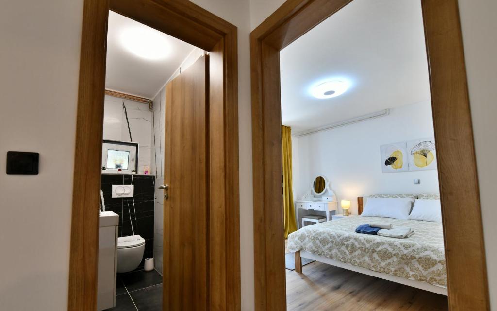 Posteľ alebo postele v izbe v ubytovaní Apartmani Brium