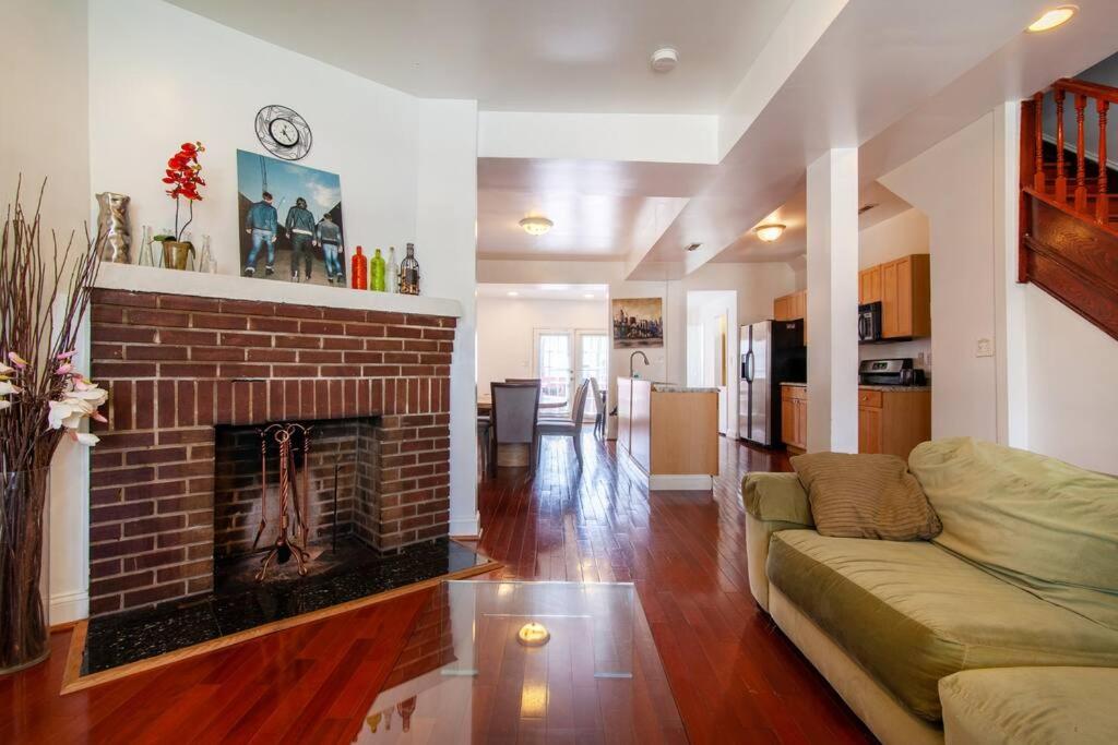 a living room with a brick fireplace and a couch at Relaxing, Spacious, Private, Walkable in Petworth! in Washington, D.C.