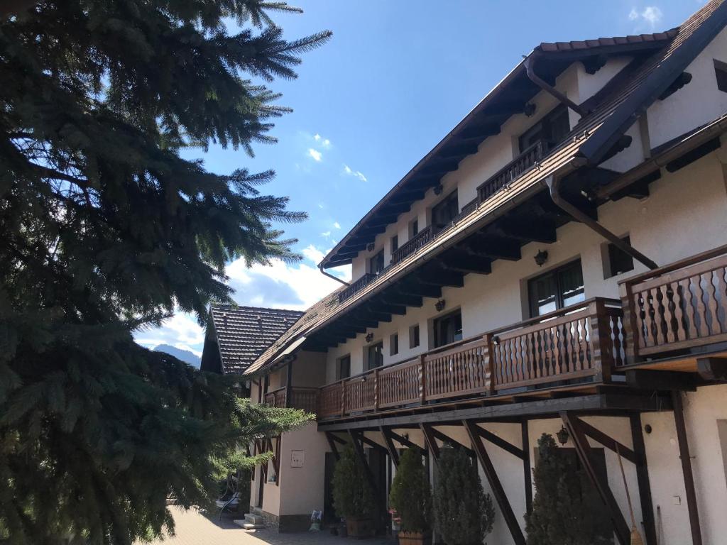 a building with a balcony on the side of it at Pensiunea Haiduc Sacele Brasov in Săcele