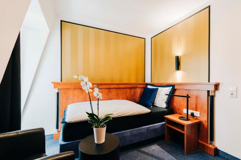 Postel nebo postele na pokoji v ubytování DAS v EVERT Hotel - am Congress Centrum Würzburg