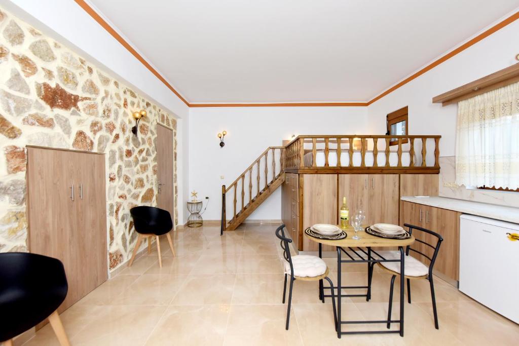 a kitchen and dining room with a table and chairs at Venus Island Studios in Lindos