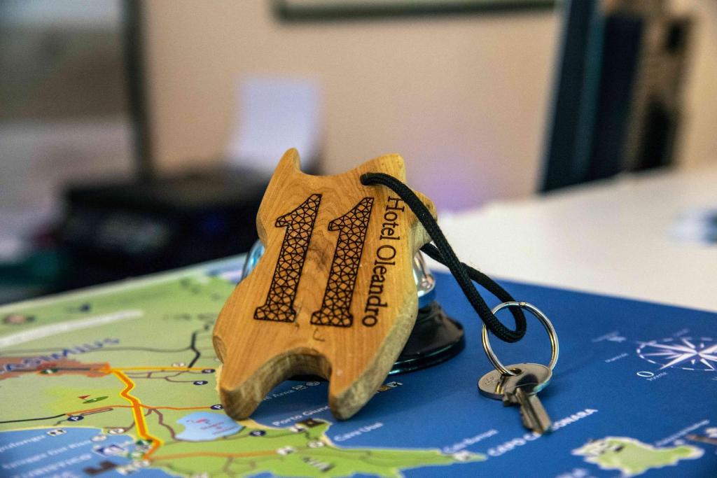 a small toy dog with a key on a map at Hotel L'Oleandro in Villasimius