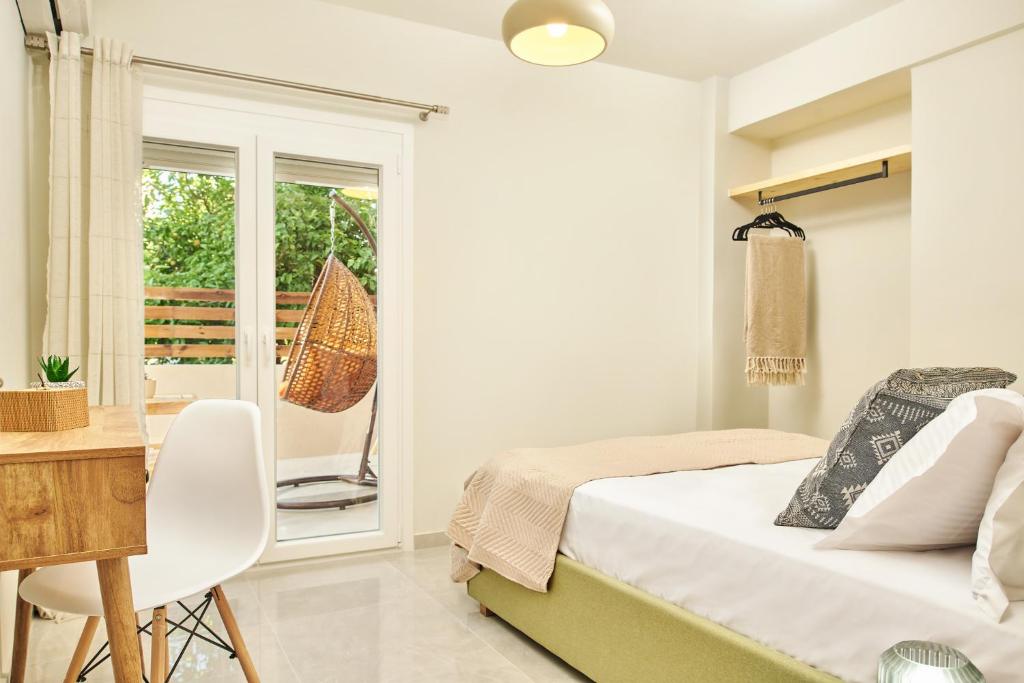 a bedroom with a bed and a desk and a window at Mariñeiro Apartment! in Zakynthos Town