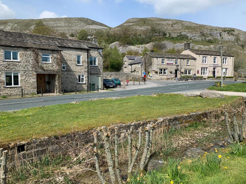 a view of a street in a village with buildings at Anglers Barn in Skipton