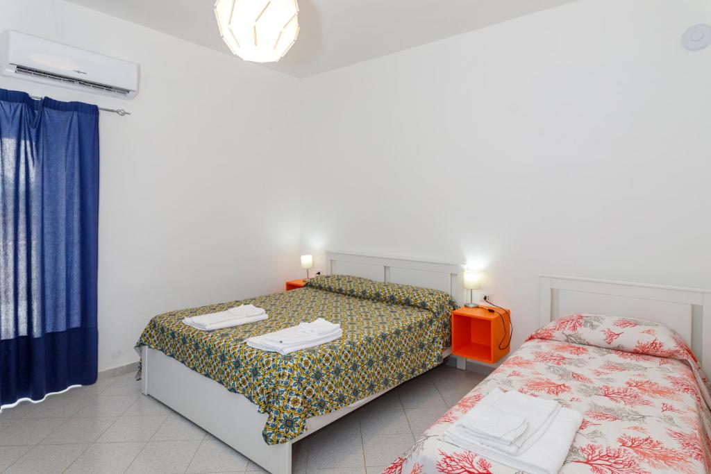 Postel nebo postele na pokoji v ubytování La Casa sul Faro
