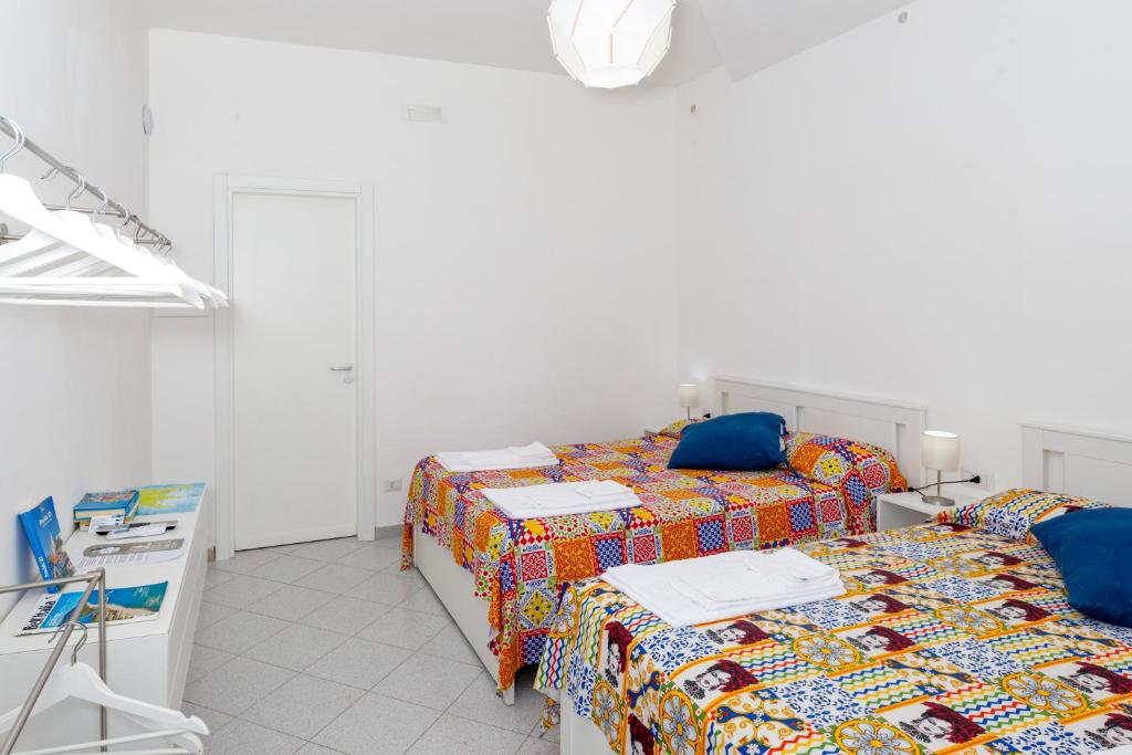 Postel nebo postele na pokoji v ubytování La Casa sul Faro
