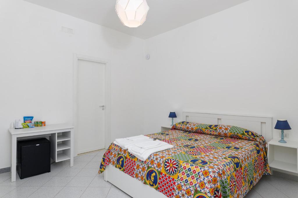 Postel nebo postele na pokoji v ubytování La Casa sul Faro