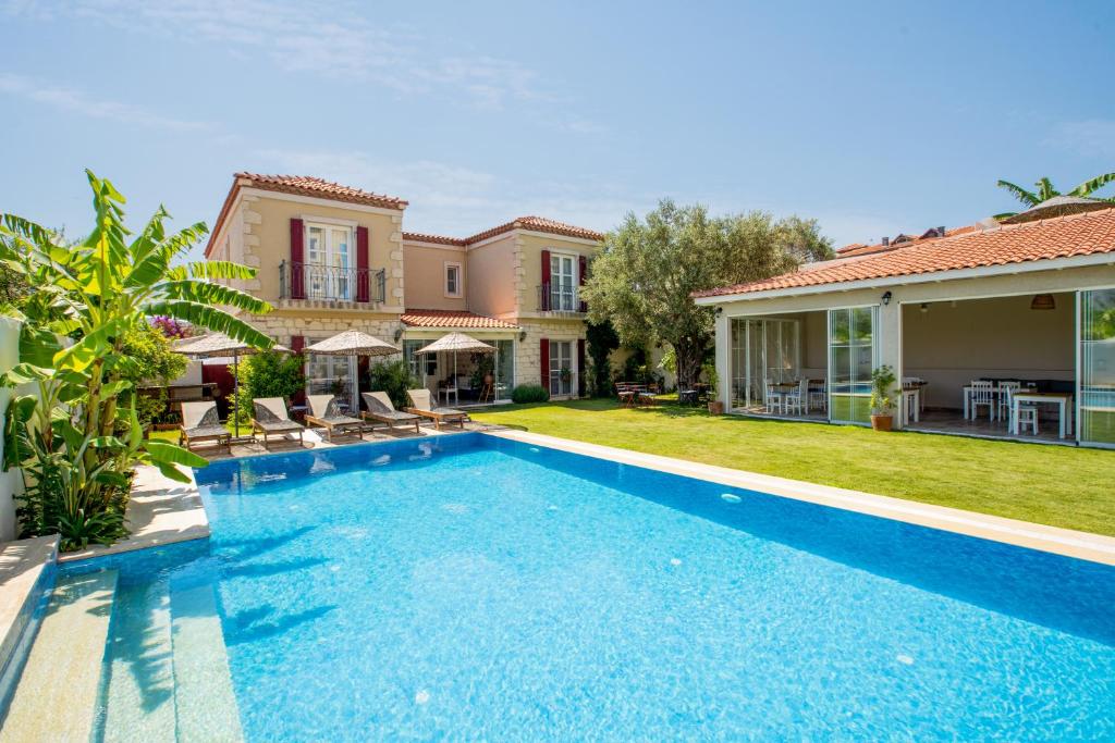 a swimming pool in the backyard of a house at Fora Konak Alacati in Alacati