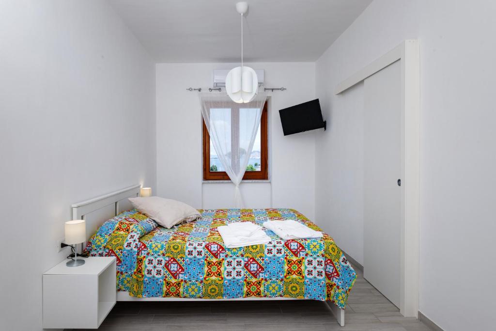 Postel nebo postele na pokoji v ubytování La Casa sul Faro