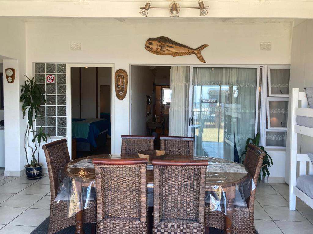 a dining room with a table and chairs at Eden Dunes 69 in Shelly Beach