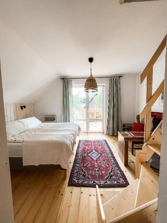 a bedroom with a bed and a large window at Istebna 401 MURY in Istebna
